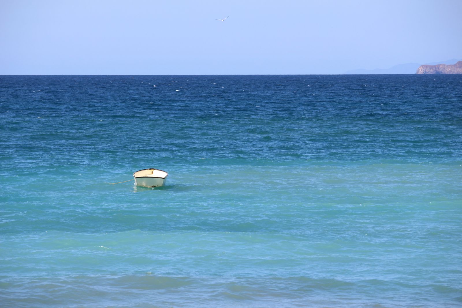 A small boat on turquoise water at Playa Conchal, Guanacaste