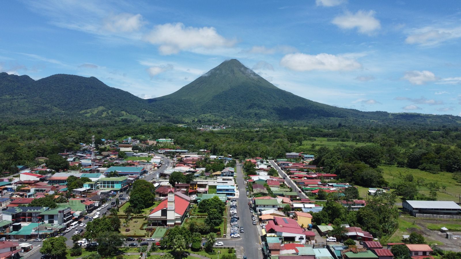 Aerial view of La Fortuna town with Arenal Volcano behind it